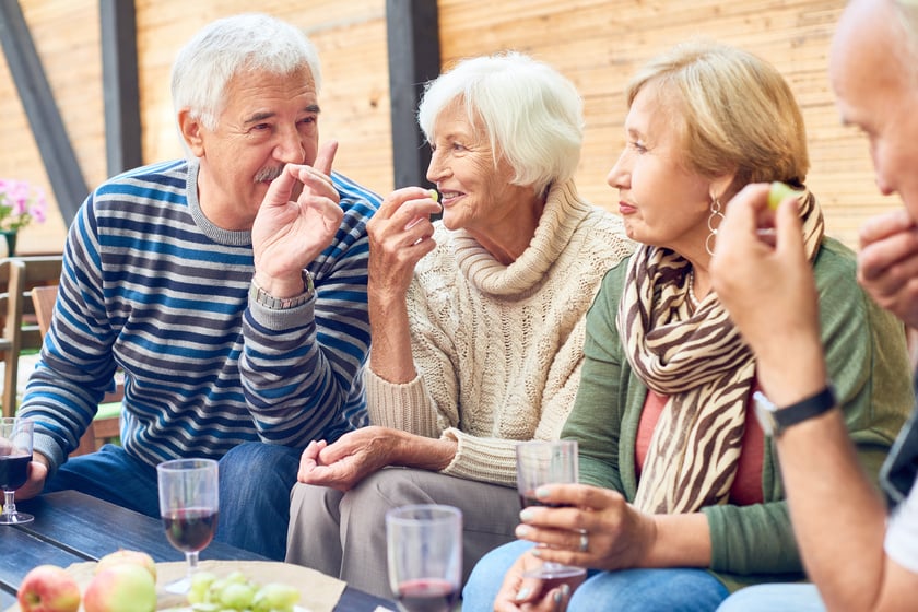 Seniors sitting and drinking wine